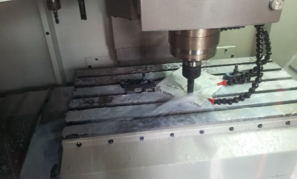 CNC vertical machining centre cutting a steel mould under flood coolant in the Silton Rubber toolroom