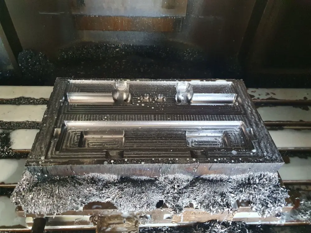 Freshly machined multi-cavity steel moulding die on the CNC bed at Silton Rubber